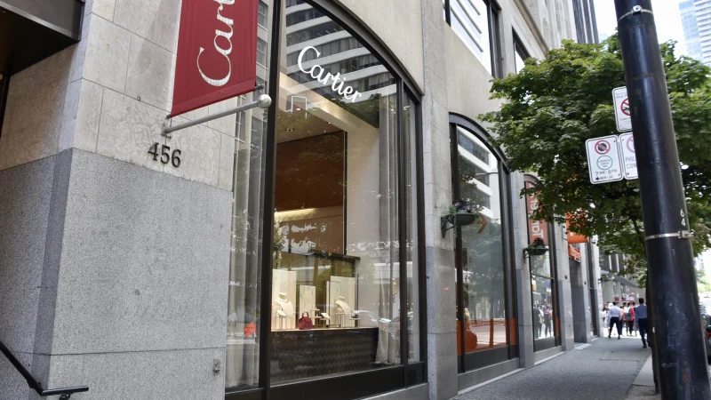 Cartier Jewellers Glass Replacement — A tall glazed entrance sits within Cartier’s stone retail frontage in Vancouver.