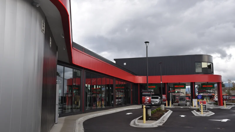 Chilliwack Speed Wash — Glazing follows the frontage of this car-wash facility beneath a bold red fascia.