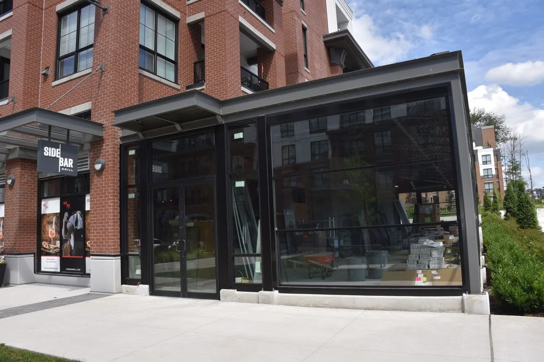 Close view of the Side Bar glazed entrance and storefront corner.