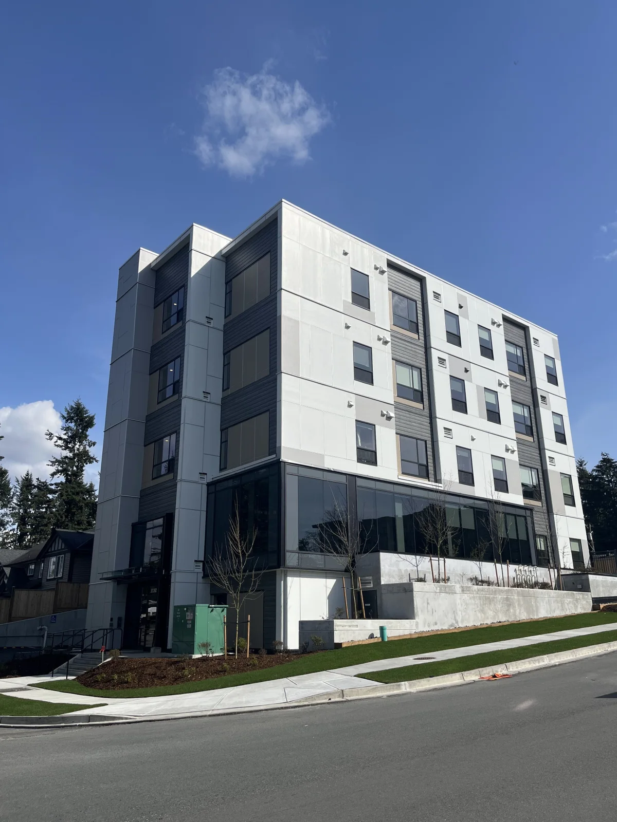 Street-corner view of Granite Ave showing the full building and ground-floor glazing.
