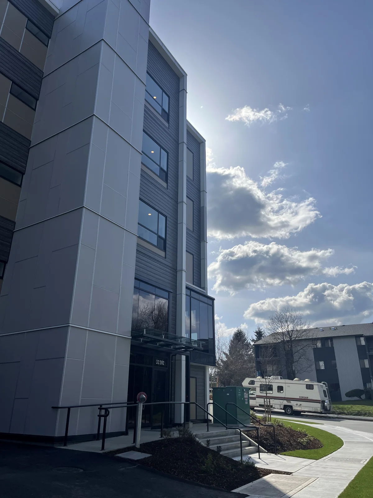 Tall side view of the Abbotsford residential building showing glazing above the entrance.