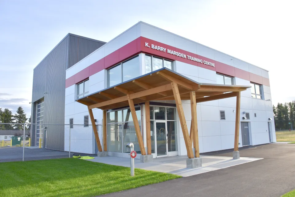 Conair Training Centre — A glazed entrance beneath a timber canopy marks the arrival point at the Conair training centre.