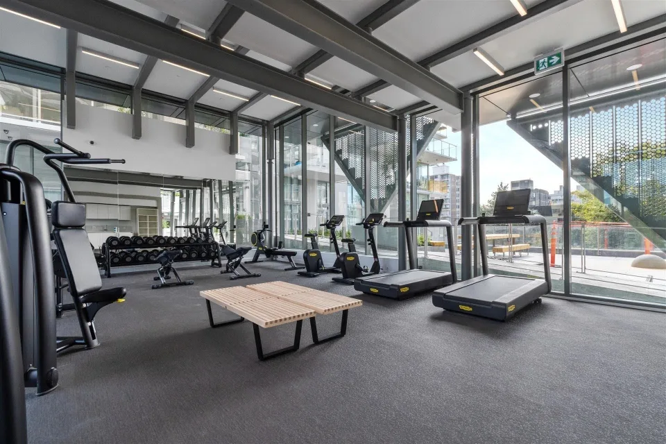 Mirabel Amenity Room — Two views of a light-filled fitness space show the glazing around the amenity room.