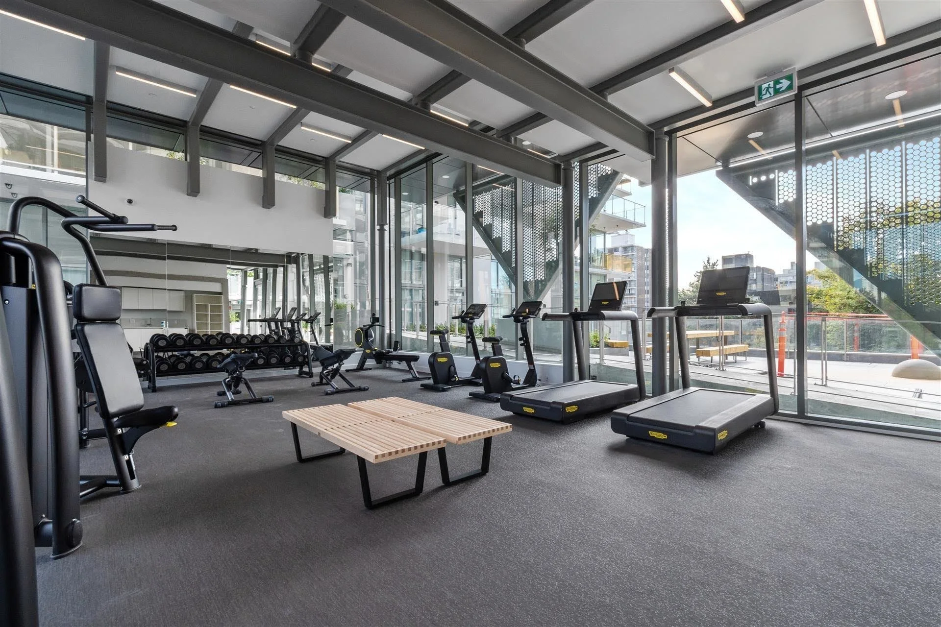 Mirabel Amenity Room — Two views of a light-filled fitness space show the glazing around the amenity room.