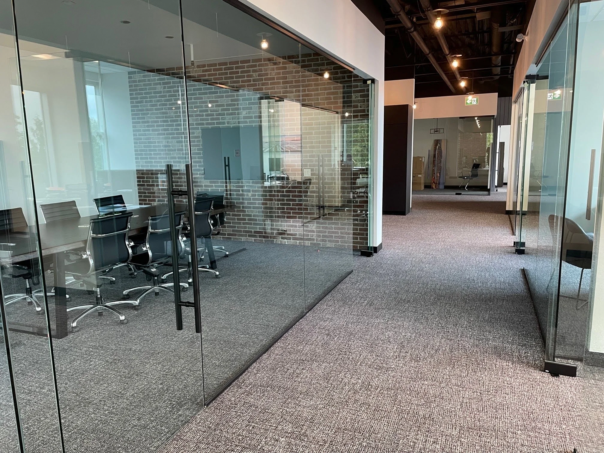 Benchmark Office — Glass partitions define a meeting room while maintaining views through the office.