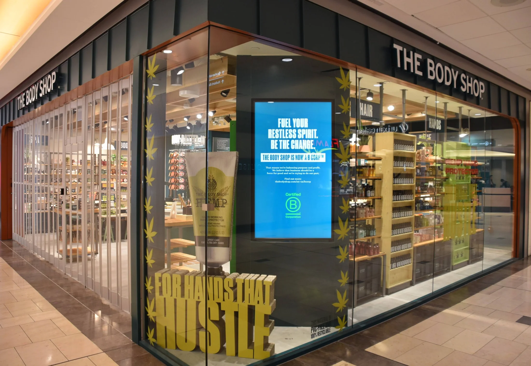 The Body Shop Interior Glazing — Corner glazing opens views into The Body Shop’s retail displays from the surrounding mall.