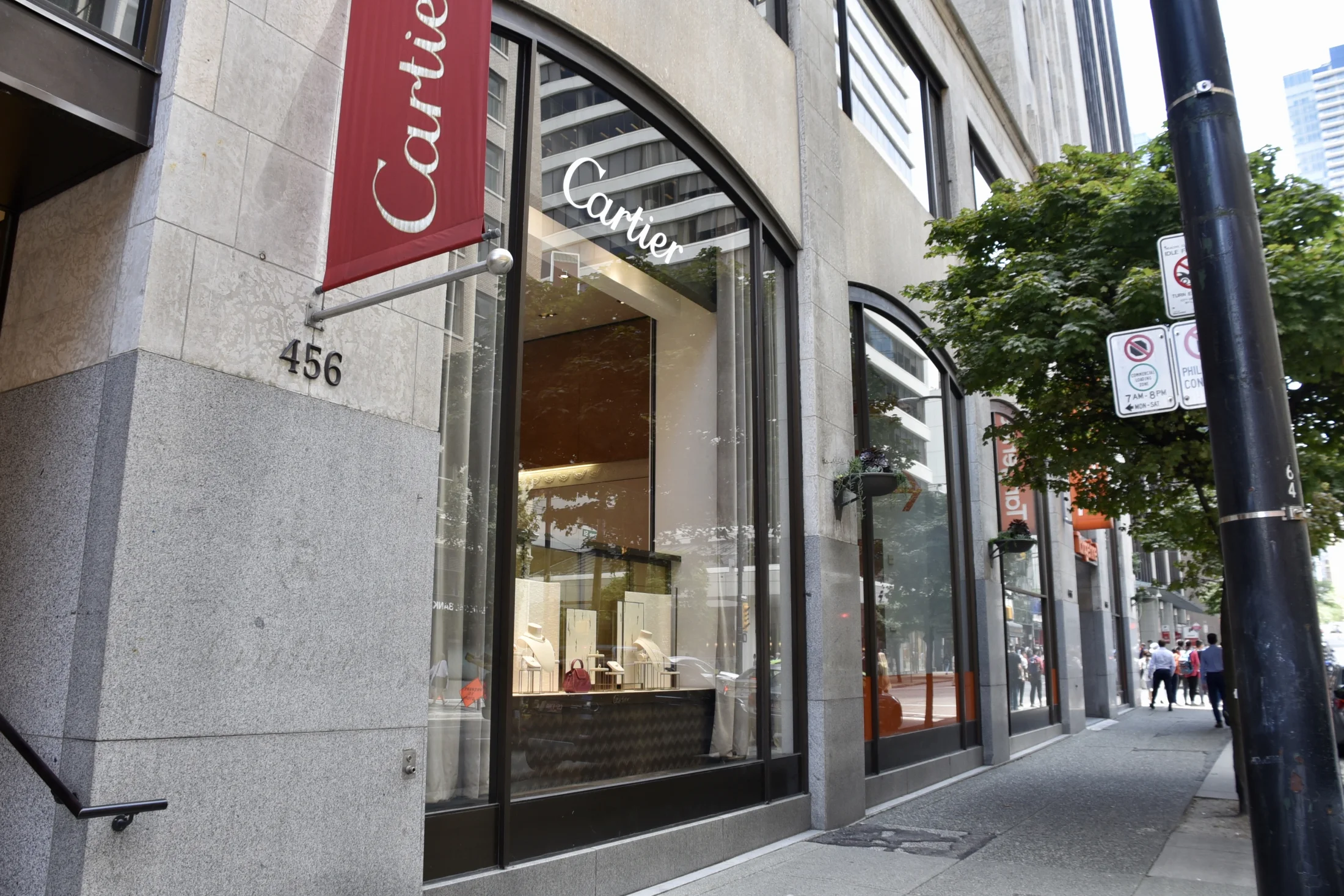 Cartier Jewellers Glass Replacement — A tall glazed entrance sits within Cartier’s stone retail frontage in Vancouver.