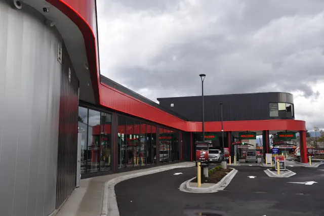 Chilliwack Speed Wash — Glazing follows the frontage of this car-wash facility beneath a bold red fascia.