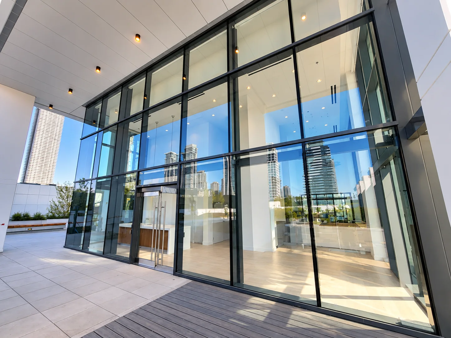 Tailor by Marcon: Wide view of the glazed lobby frontage and double-door entrance.